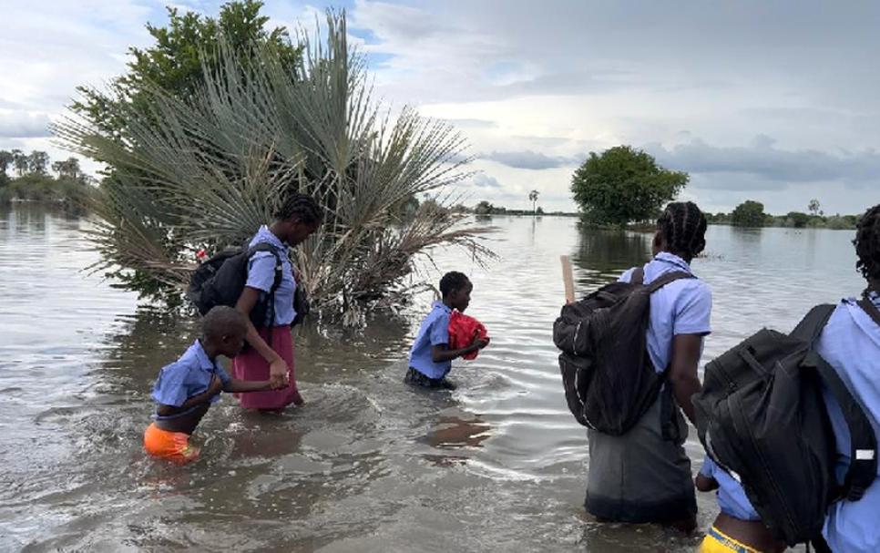 kids going to school in a flood