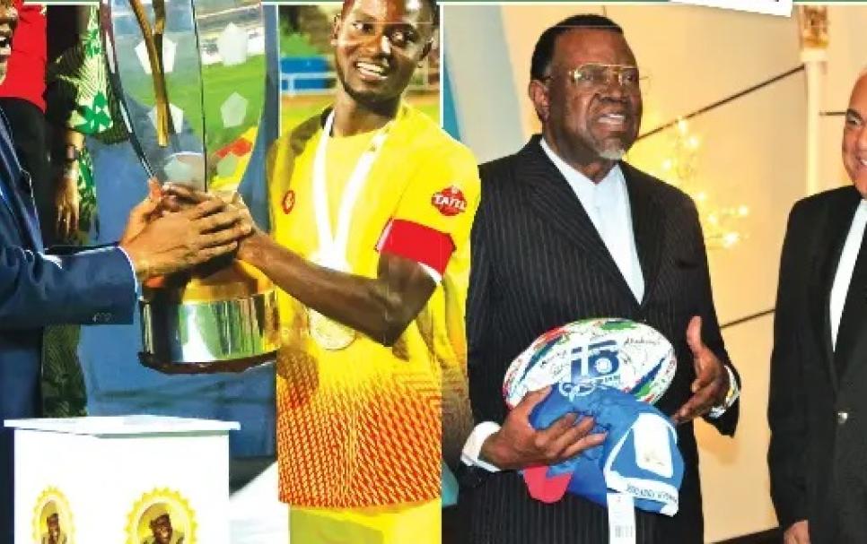 Late President Hage Geingob holding the Dr Hage Geingob Cup and a r ugby ball